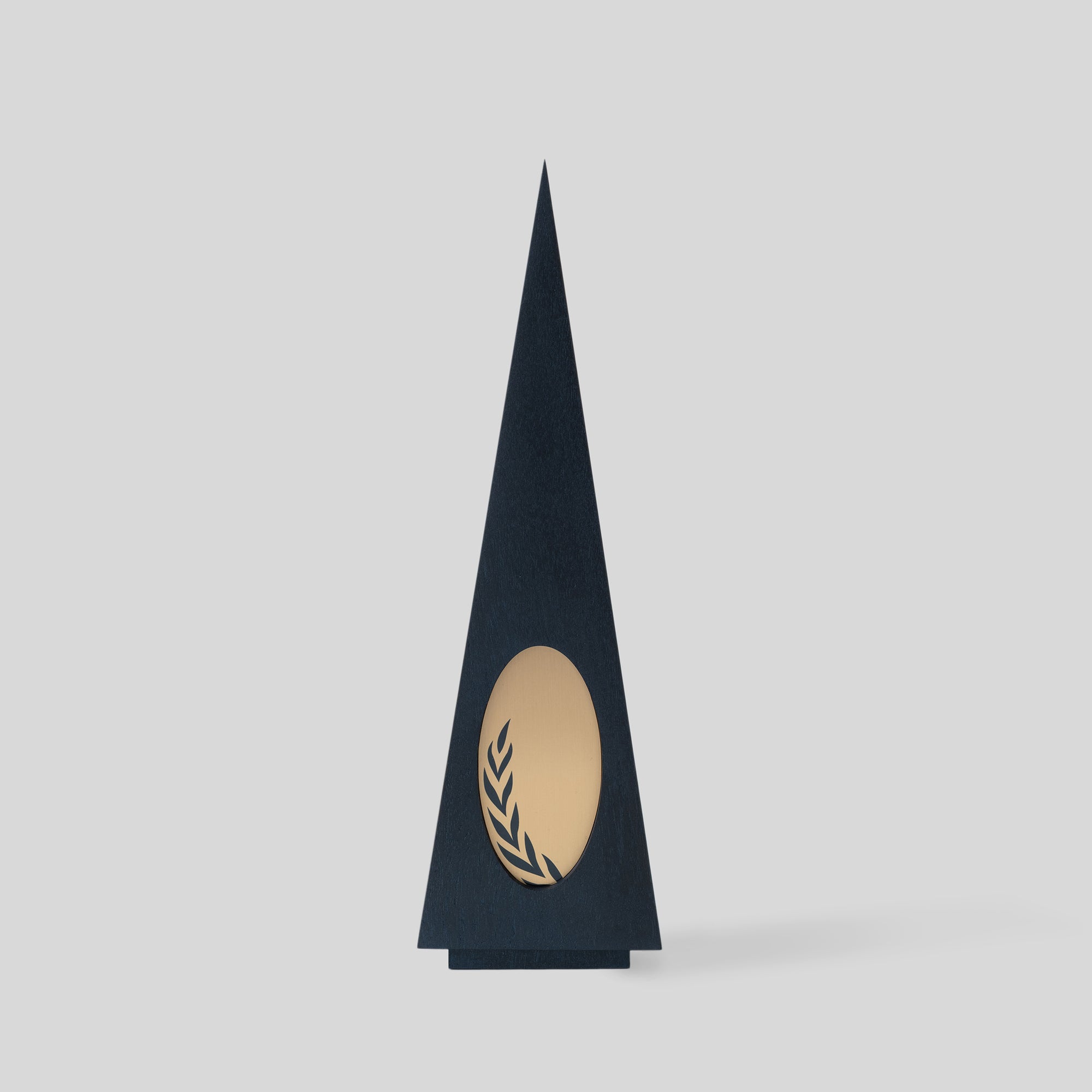 Gracilia Oval Award, a tall modern triangular trophy with a distinctive metal oval accent, exemplifies luxury and customizable design for unique recognition. Architect-designed and artisan-crafted in the USA combining wood and metal.