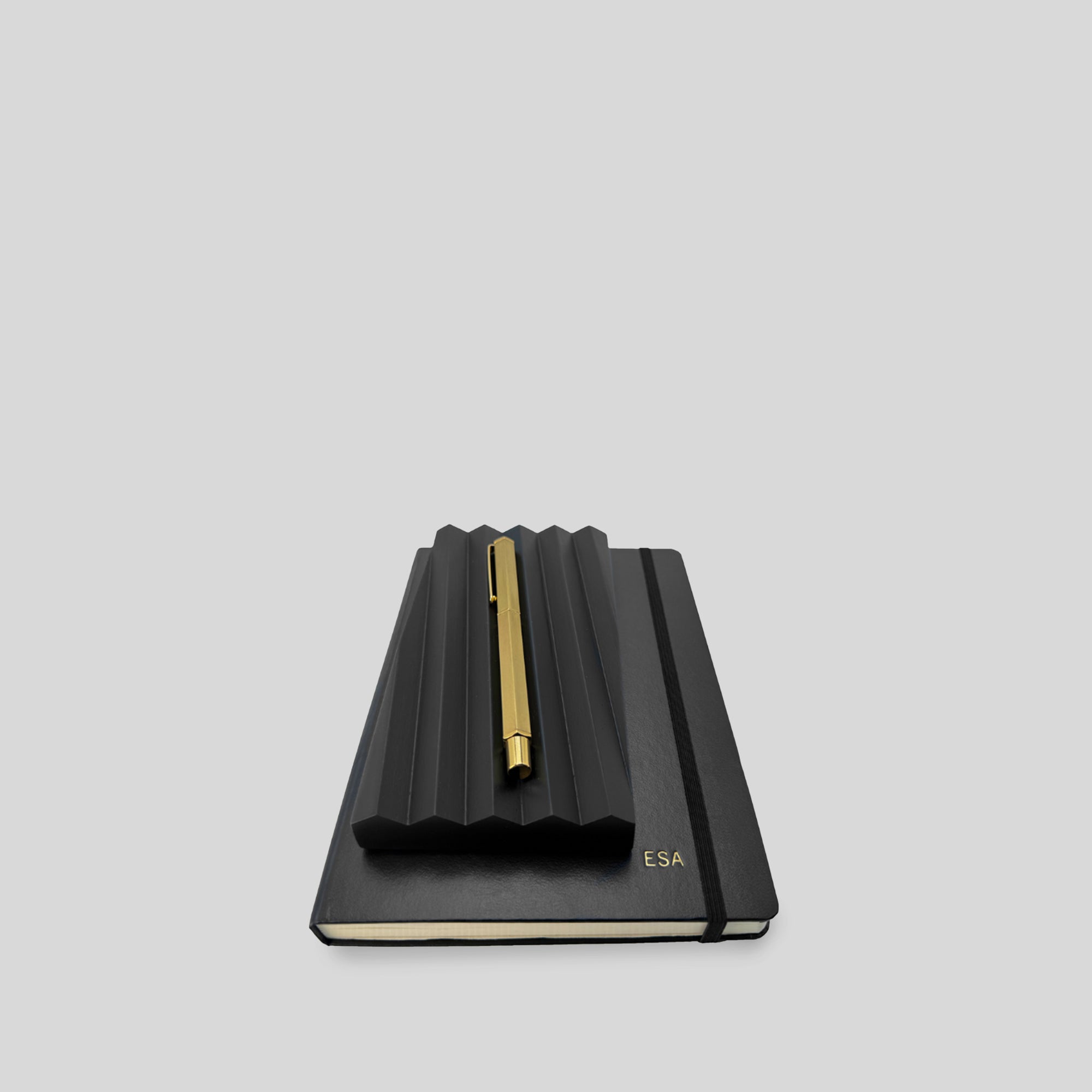 Curated business gift set 'thanking by hand' featuring a black embossed notebook with an elegant black wood pen tray, quality brass pen, ideal for personalized, elegant corporate gifting.