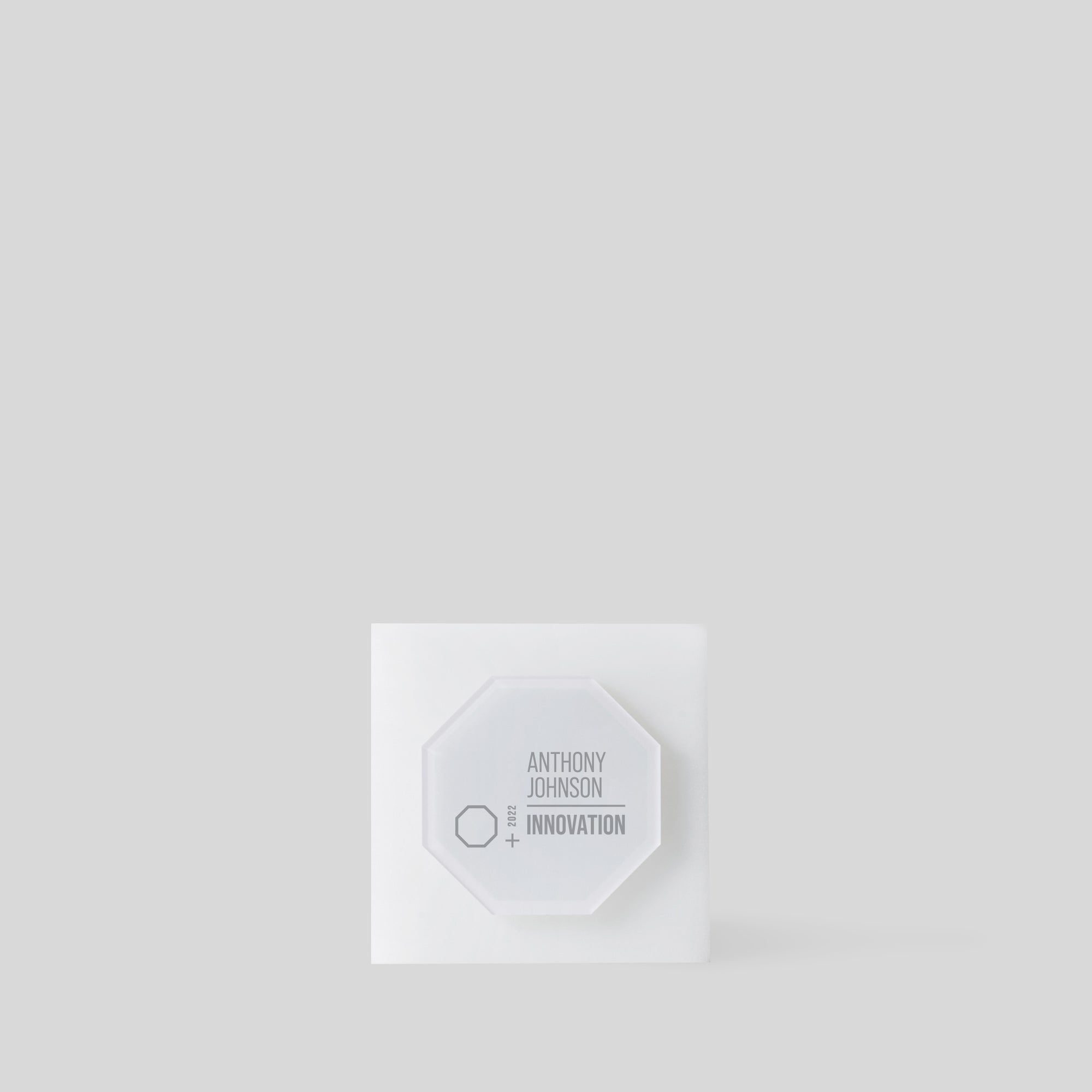 Modern Glacio Award Octagon features a geometric octagonal plate on a square acrylic base, symbolizing transformation and balance, ideal for celebrating significant achievements. Made in the USA.