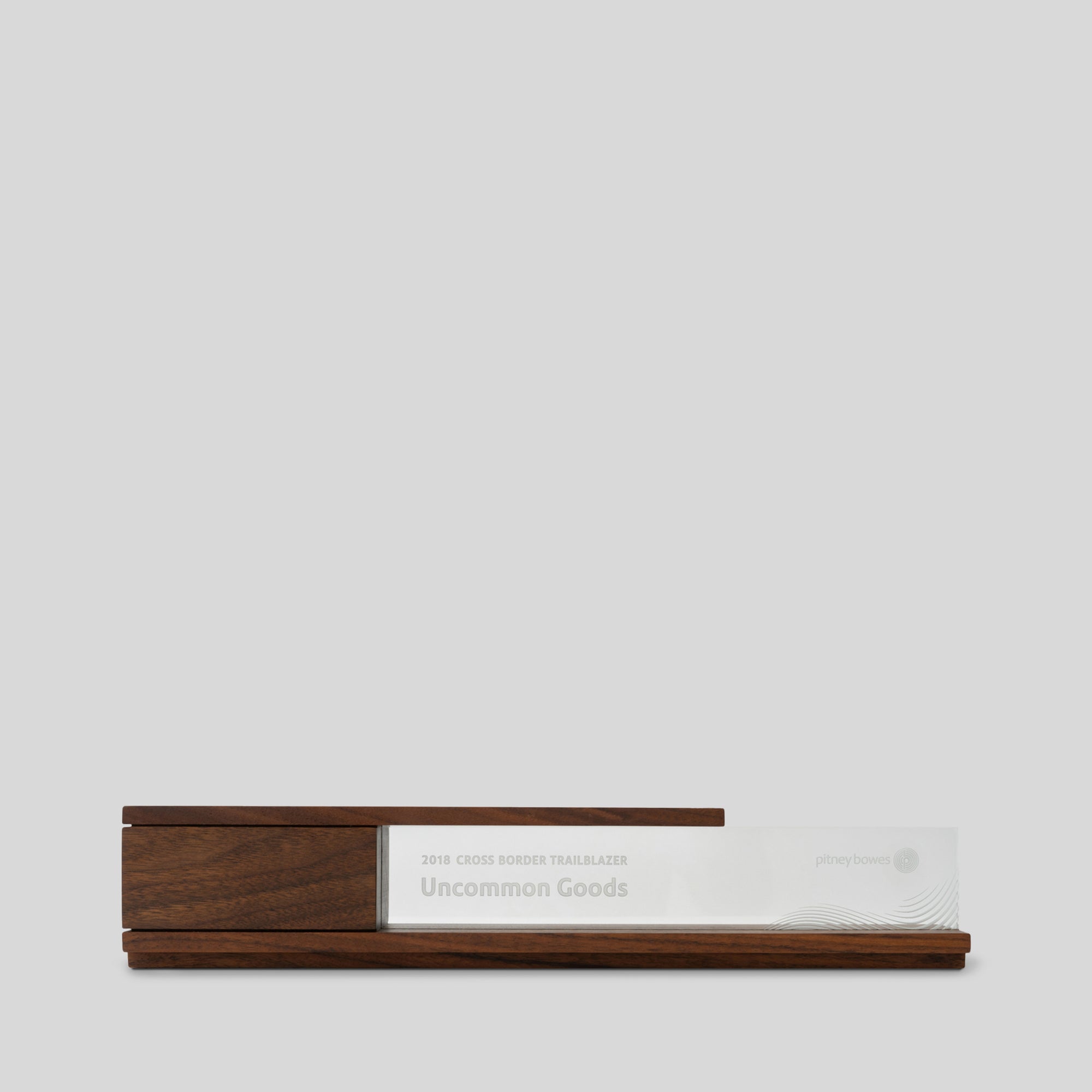 Portico | A high-end wooden trophy with a glass nameplate, featuring classic modern lines and a cantilevered top, ideal for executive recognition and lifetime achievement awards. Made in the USA, architect-designed and artisan crafted.