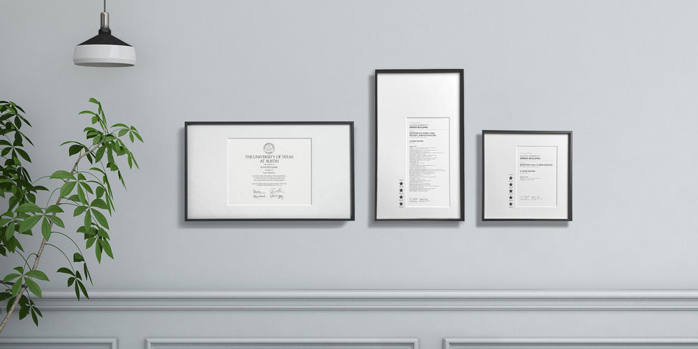 Custom award certificates composition on a wall that shows an academic diploma, and two recognition certificates with personalization and laser-engraving. 