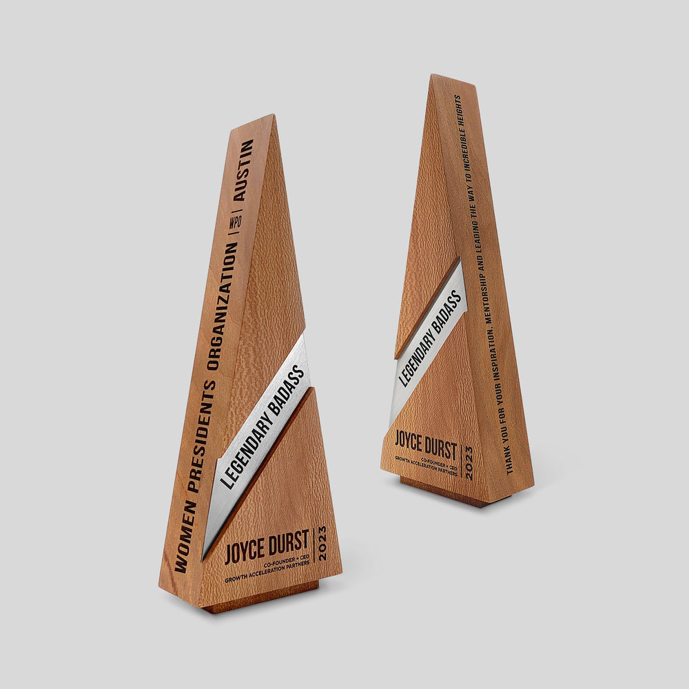 Gracilia Ribbon Award: wooden triangle trophy featuring a metal nameplate ribbon, highlighting timeless design and customizable options for personal recognition. Elegant engraving on wood and metal.