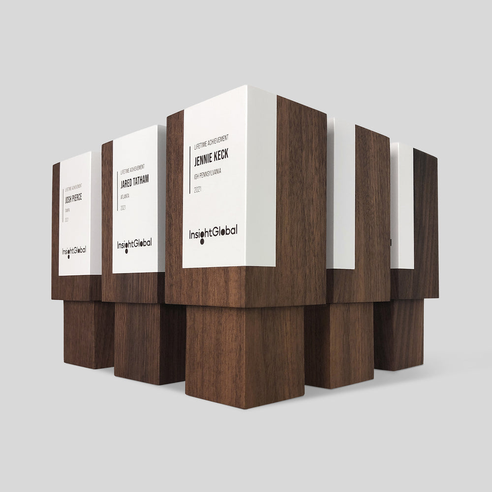 Geometria Award Rectangulus features wooden boxes with minimalist design, showcasing engraved labels on solid walnut or maple, symbolizing strength and craftsmanship.