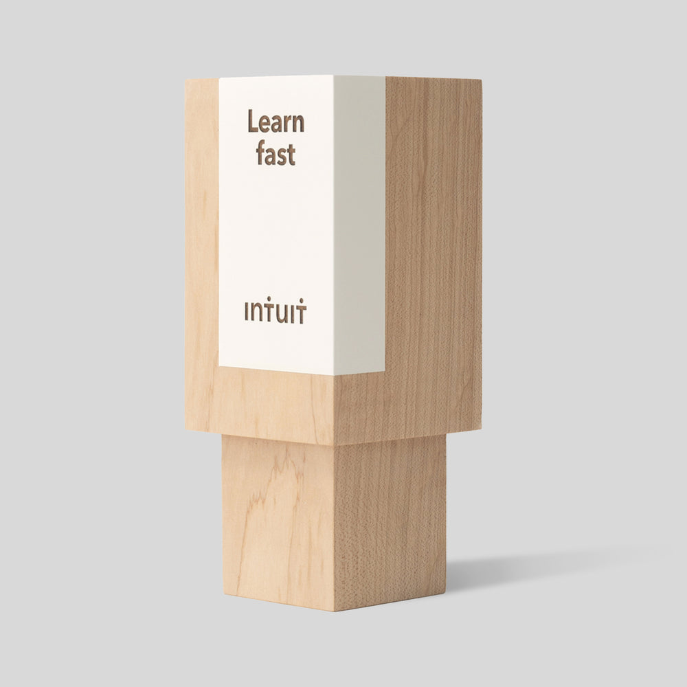 Geometria Award Rectangulus, a solid wood block with minimalist design, featuring laser-engraved text. Part of the Geometria Collection, embodying strength and craftsmanship.