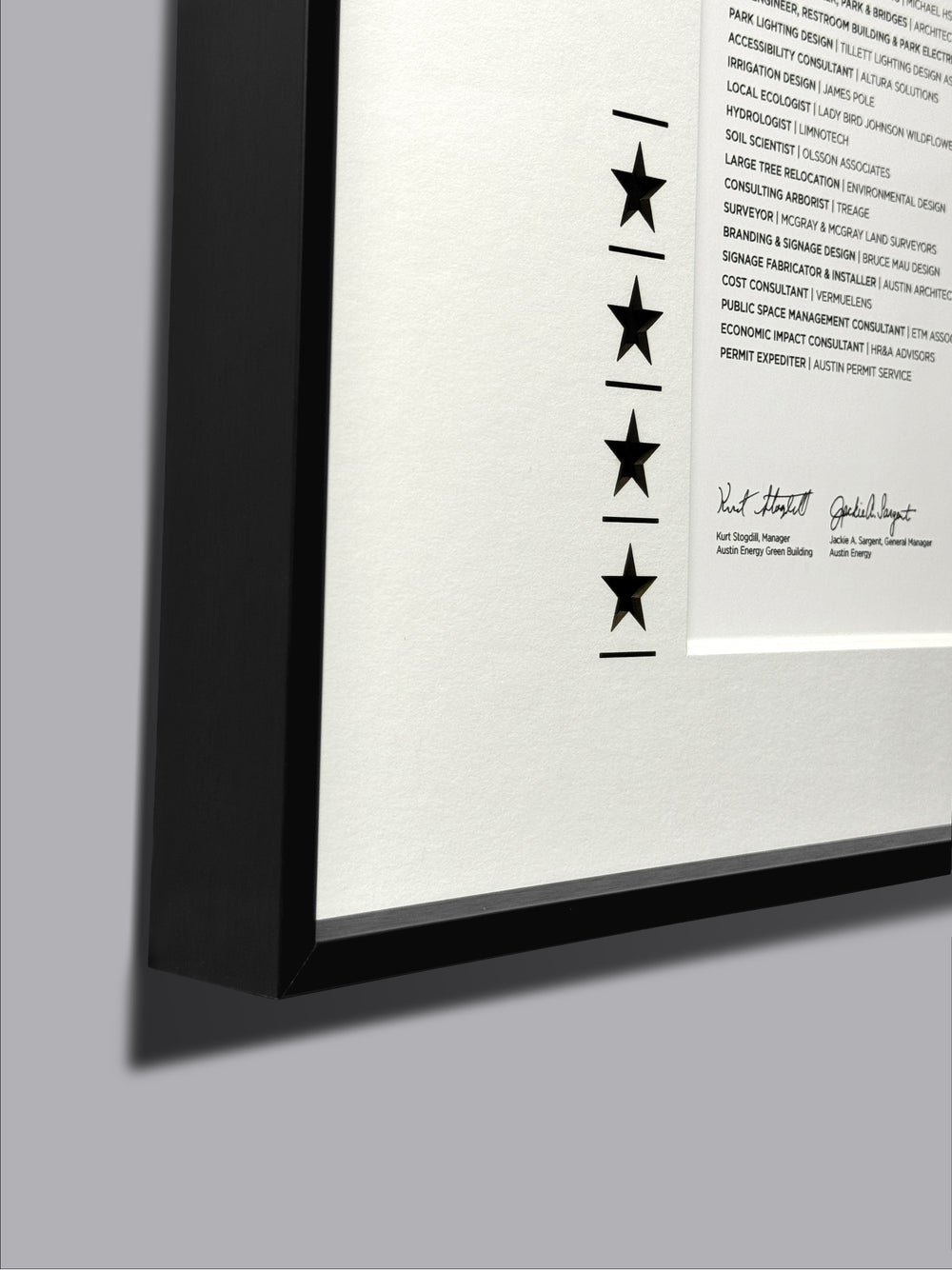 Framed Certificate in Black Frame showcasing a star-shaped design with text, ideal for display or recognition purposes.