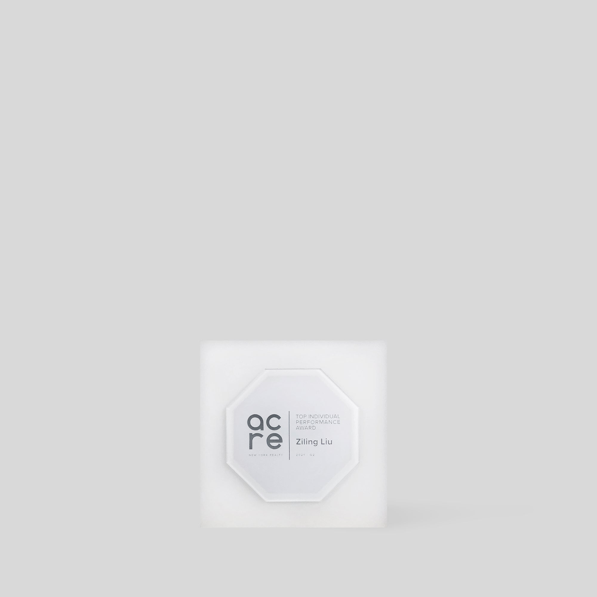 Glacio Award Octagon: A frosted, octagonal-shaped acrylic award with text, featuring minimalist design and a square base, symbolizing transformation and achievement, perfect for quarterly awards and company values trophies. 