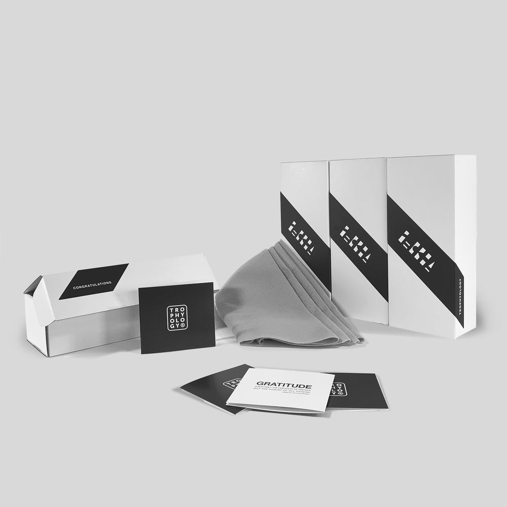 Trophyology’s sustainable, gift-ready packaging for Zayo’s President’s Club awards, including recycled-felt wrap, custom presentation boxes, and branded elements.