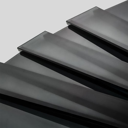 Stack of black geometric glass nameplates ready for glass-etching for corporate recognition awards