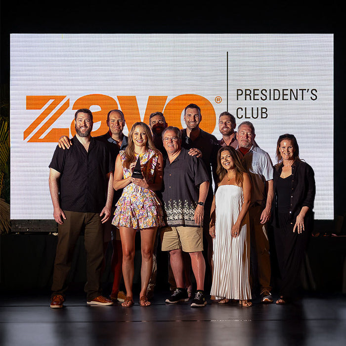 roup of Zayo President’s Club honorees on stage with custom Trophyology awards.