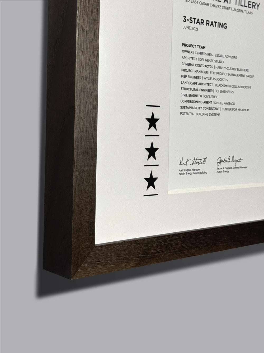 Custom award certificate in a solid walnut frame, featuring laser-engraved stars and text, highlighting the detailed craftsmanship of the frame.