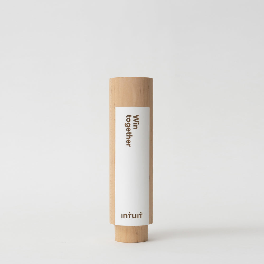 Geometria Award Circulus: A wooden cylinder with a white color field, circular trophy shape symbolizes unity and growth, crafted from walnut or maple with a minimalist design. Architect-designed and artisan-crafted in the USA. 