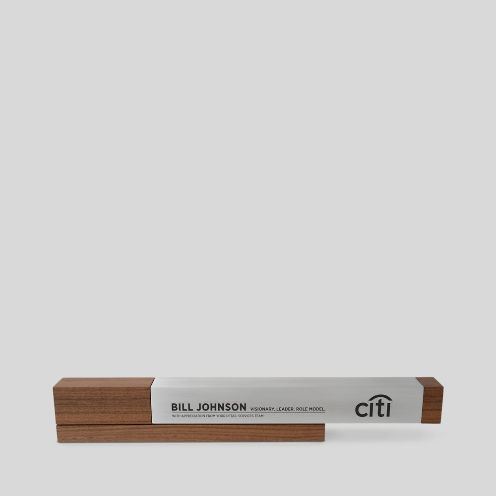 Fulgeo Award featuring a cantilevered brushed aluminum beam and solid walnut base, symbolizing innovation and strength, crafted for impactful achievements, such as corporate awards and lifetime achievement trophies.