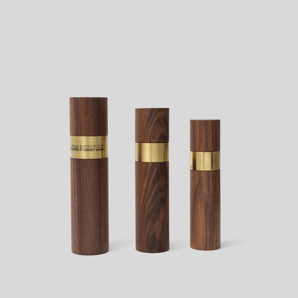 Stela Round Award | Small: Group of cylindrical wooden objects with gold brass bands, showcasing unity and craftsmanship in luxurious wood and metal design. Unique, modern, architect-designed and artisan-crafted in USA. 