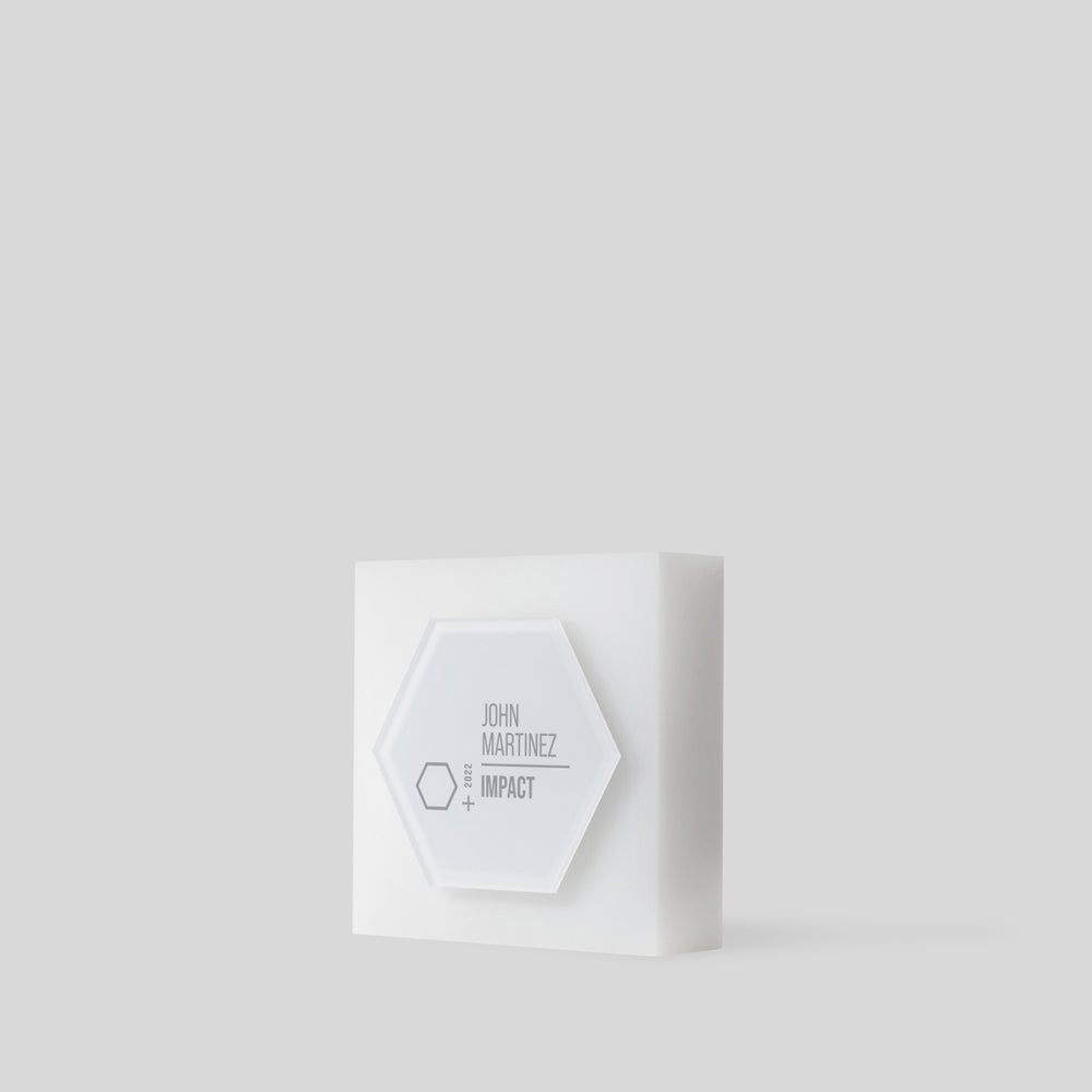 Modern acrylic trophy Glacio Award Hexagon: A frosted hexagon-shaped award on a square base, symbolizing collaboration and excellence, with customizable surface for personalization.