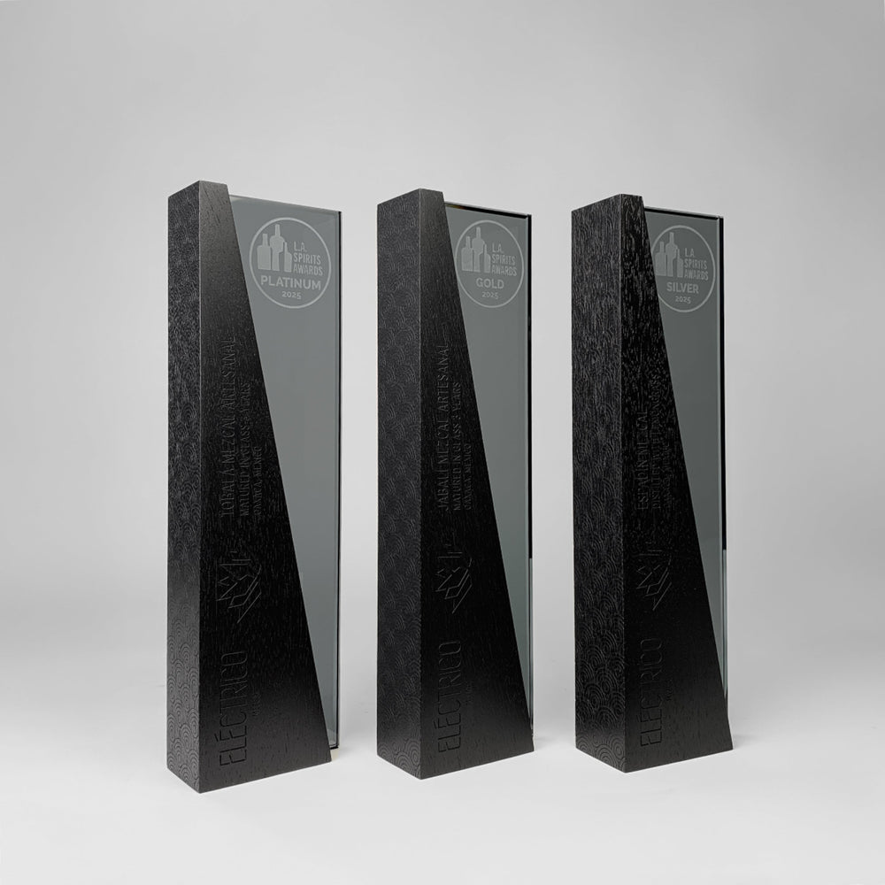 Set of DIMI Collection trophies by Trophyology, featuring wood and dark grey glass, engraved and personalized for the 2025 L.A. Spirits Awards winner Electrico Mezcal.