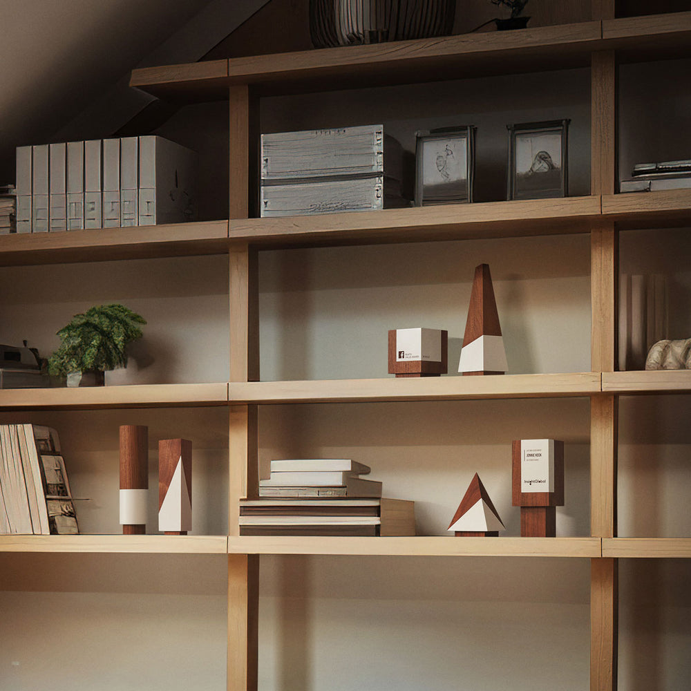 Unique corporate awards in various geometric shapes on a modern shelf in an office space