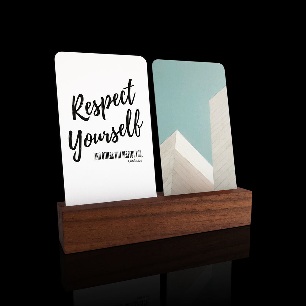 Inspirational Desk Card Collection displayed in a card holder featuring curated art and quotes, accompanied by a crafted wood stand for office decor.