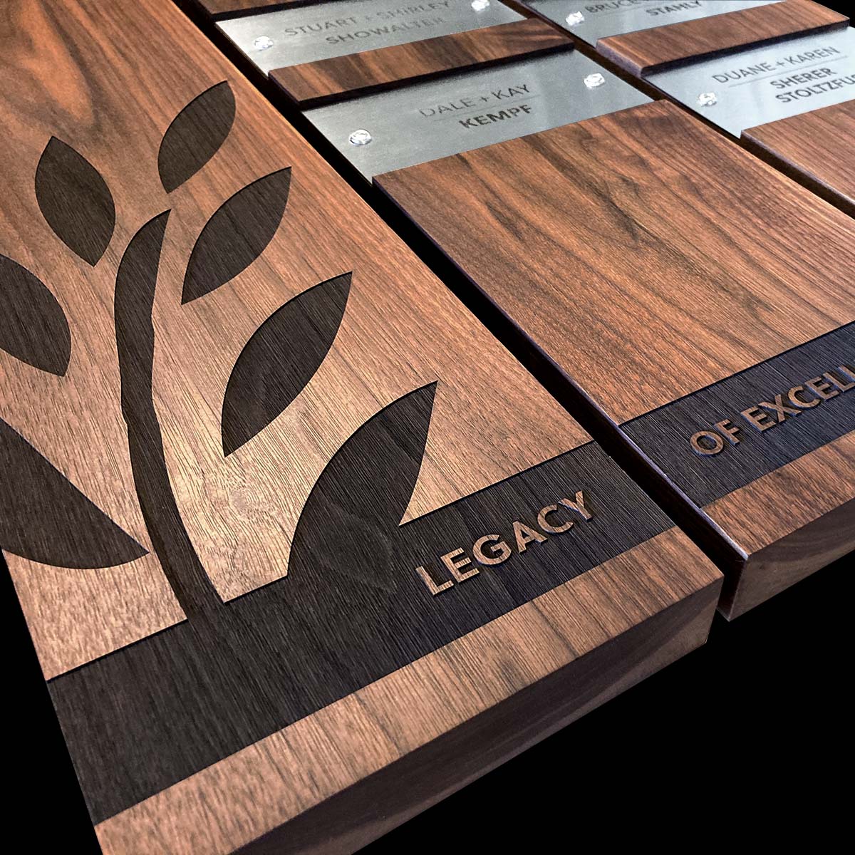 Perpetual Plaques: modern mixed-media design, featuring engraved wood modules and personalized metal nameplates, unique, flexible, elegant, ideal for personalized and meaningful recognition and organizational wall displays.