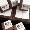 Sustainable walnut wood and white paint engraved cube awards for AIA Austin.