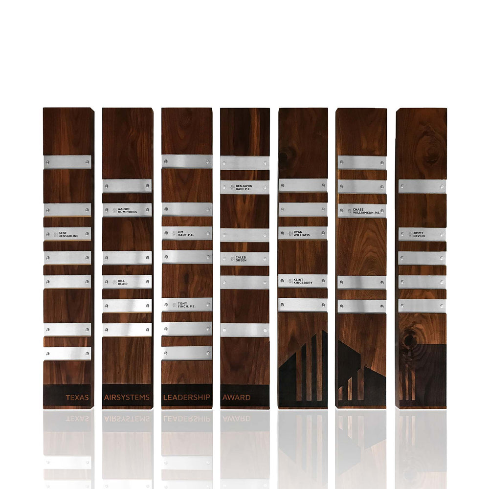 Perpetual Plaques: A wooden plaque installation featuring multiple engraved wood modules and silver metal nameplates with name engraving, large brand engraving on wood. 